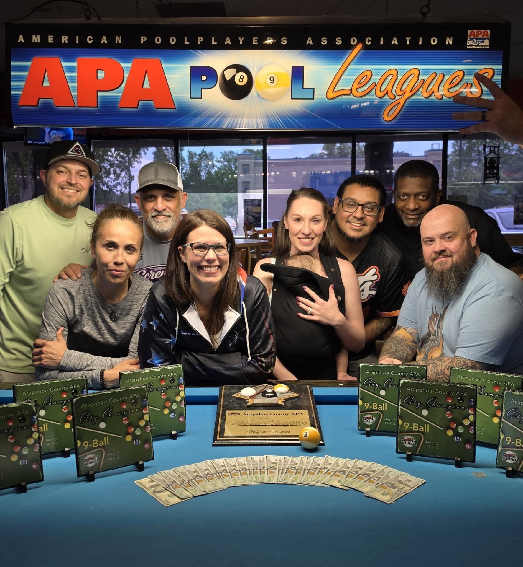 Arapahoe County APA 9-Ball City Champions team celebrating with plaques and prize money at NayNay's Famous Door